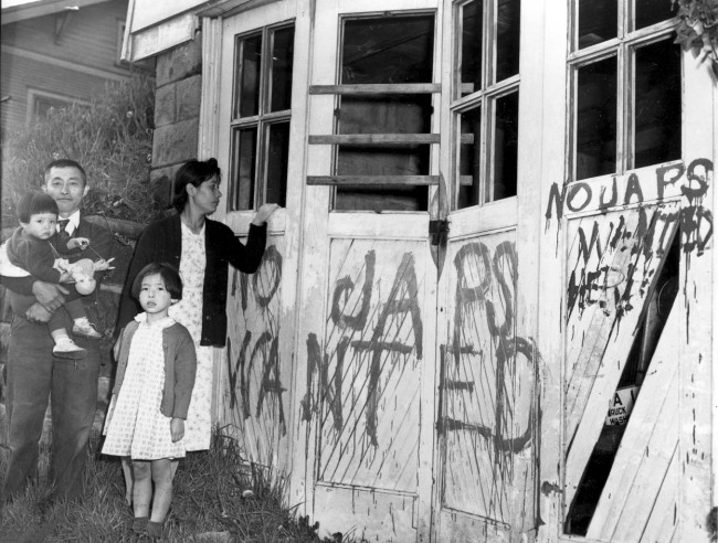 A Japanese family returning home from a relocation center camp in Hunt, Idaho, found their home and garage vandalized with anti-Japanese graffiti and broken windows in Seattle, Washington, on May 10, 1945. (AP Photo)